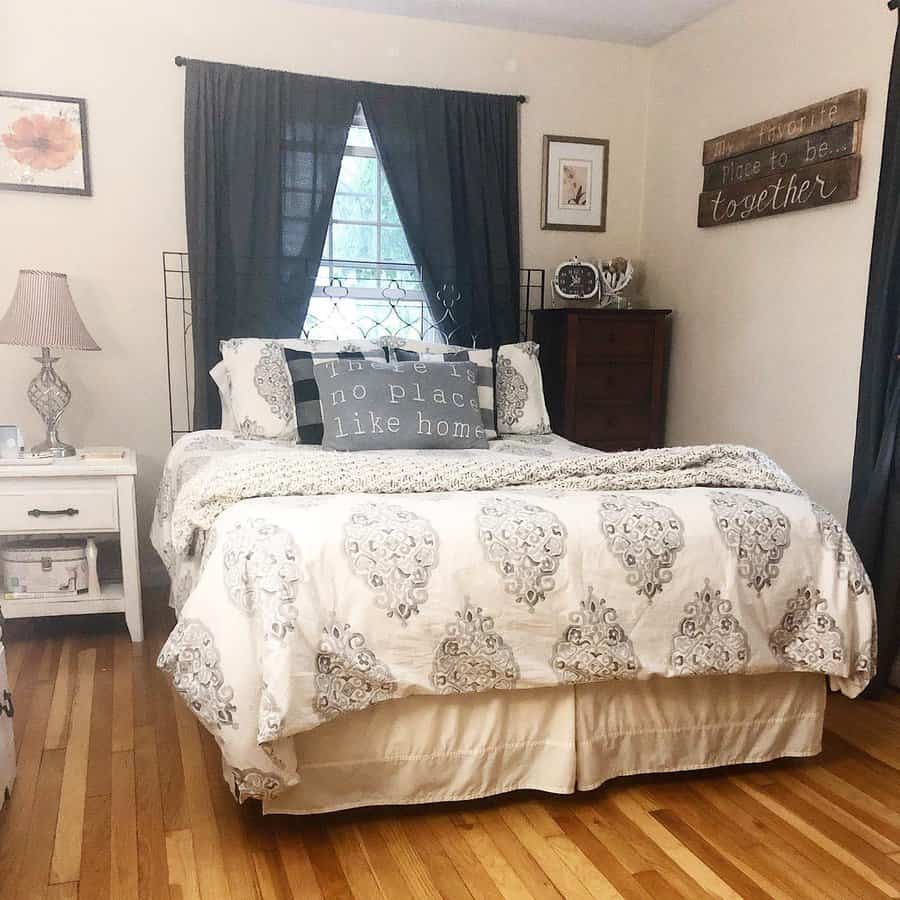 Homely bedroom with wood floors and heartfelt quote pillows