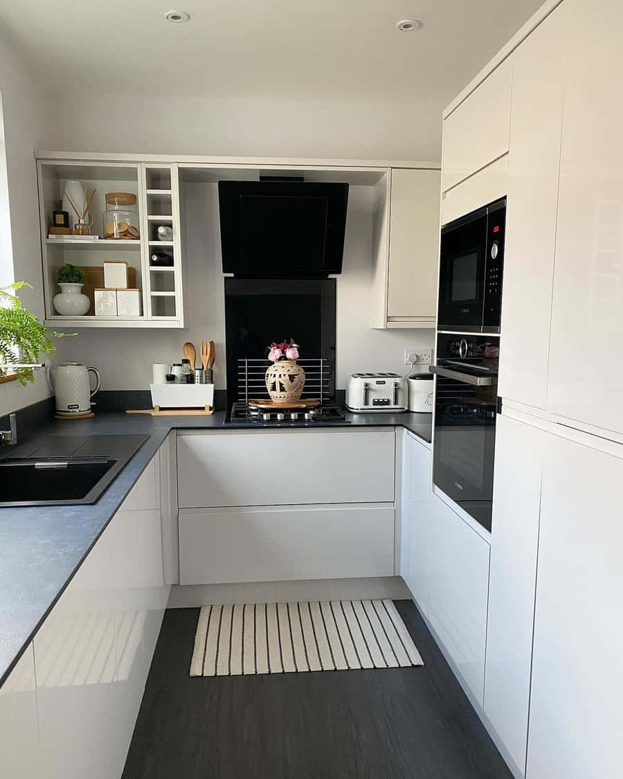 Stylish kitchen with contrasting black and white cabinets and open shelving