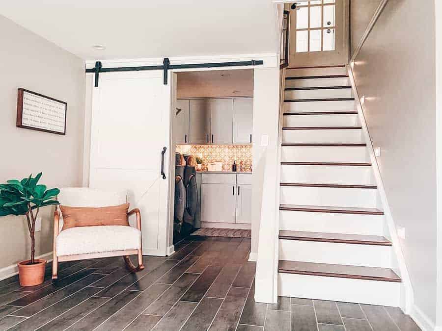 Cozy living room with wooden stairs and a rocking chair