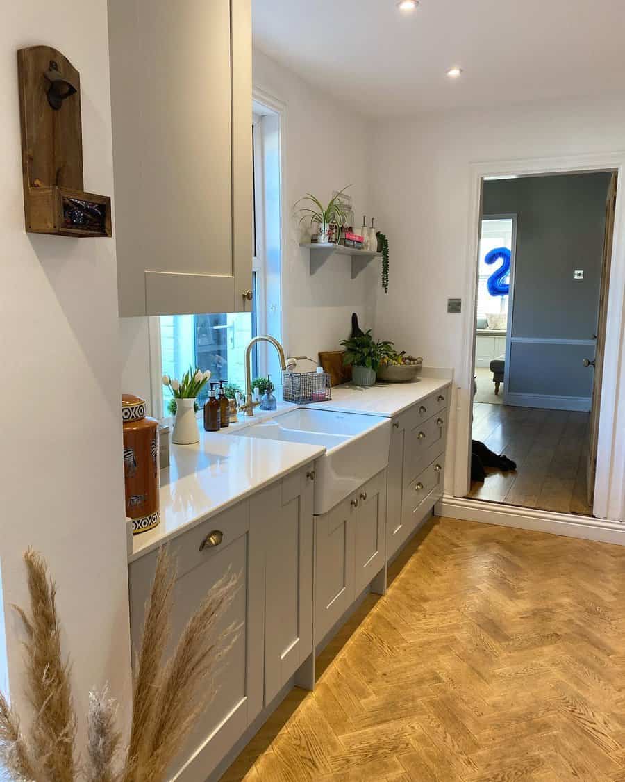 Modern narrow kitchen with herringbone floor