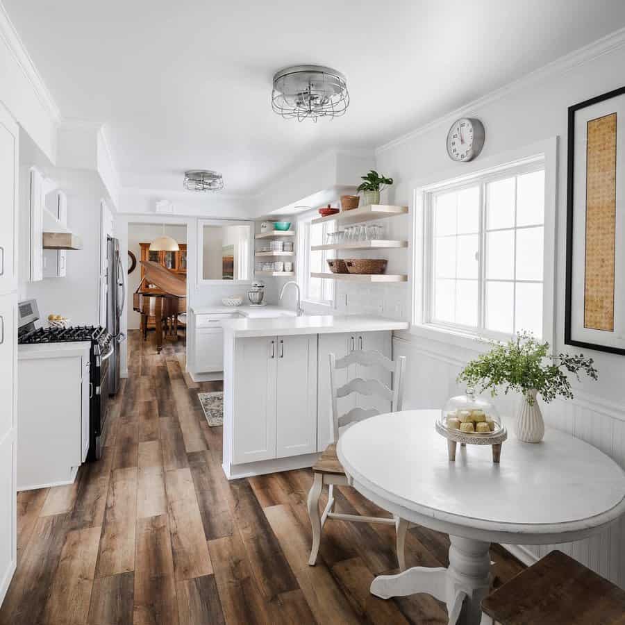 Organized kitchen with wood floors and white cabinets