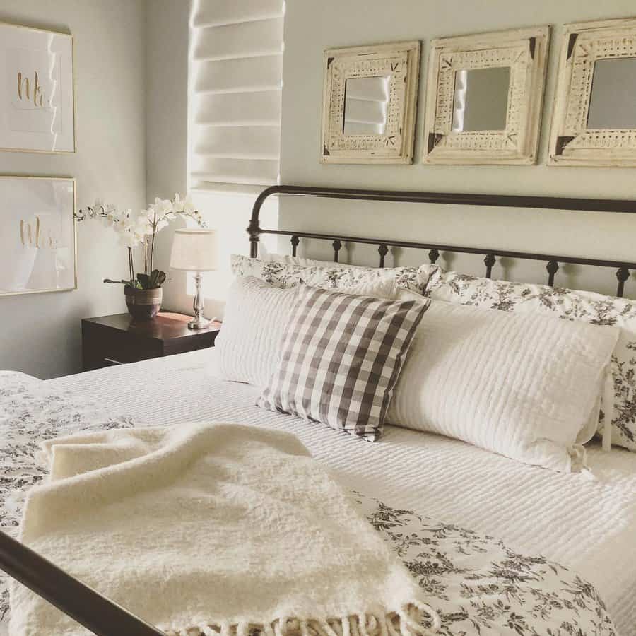 Country chic bedroom with gingham pillow and ornate mirrors