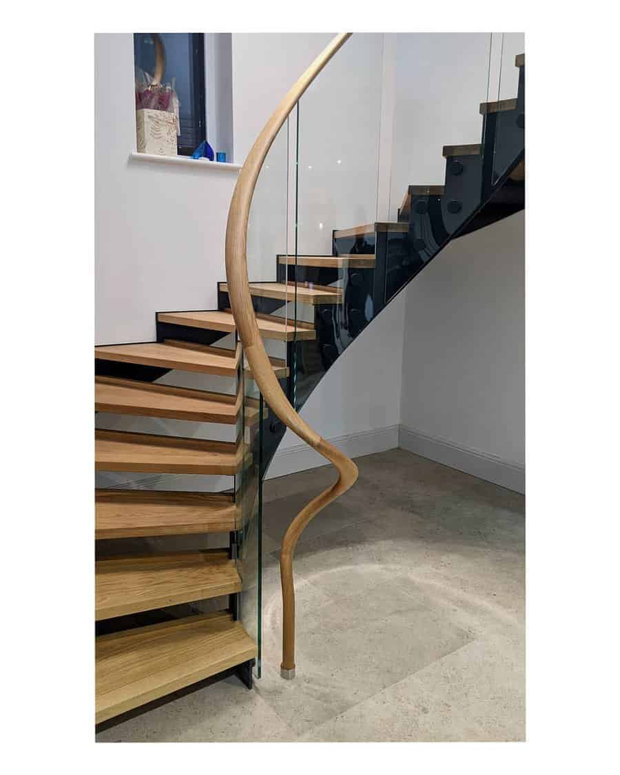 Circular glass stairway with wooden steps