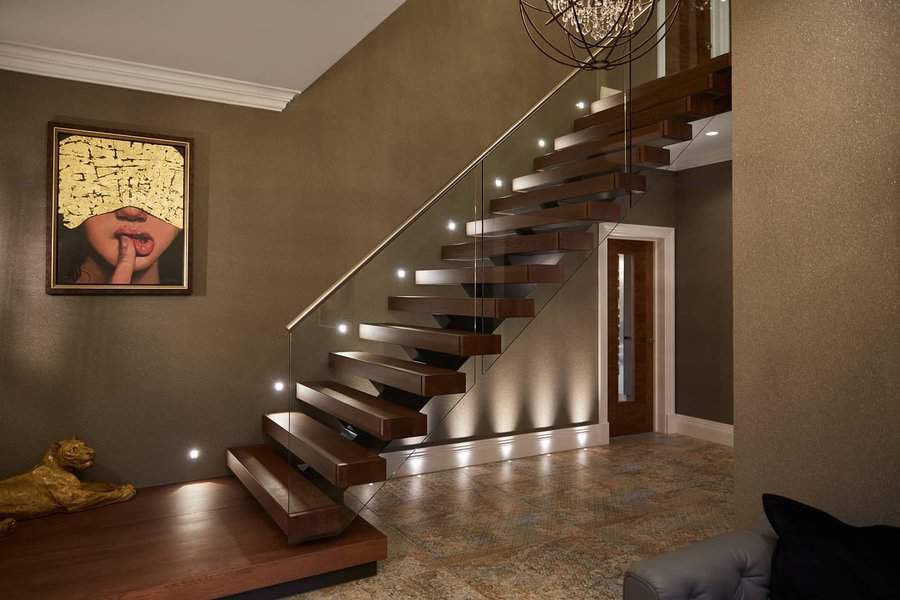 Glass staircase with wall painting and a chandelier