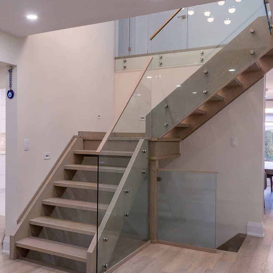 Modern staircase with glass railings and wooden stairs