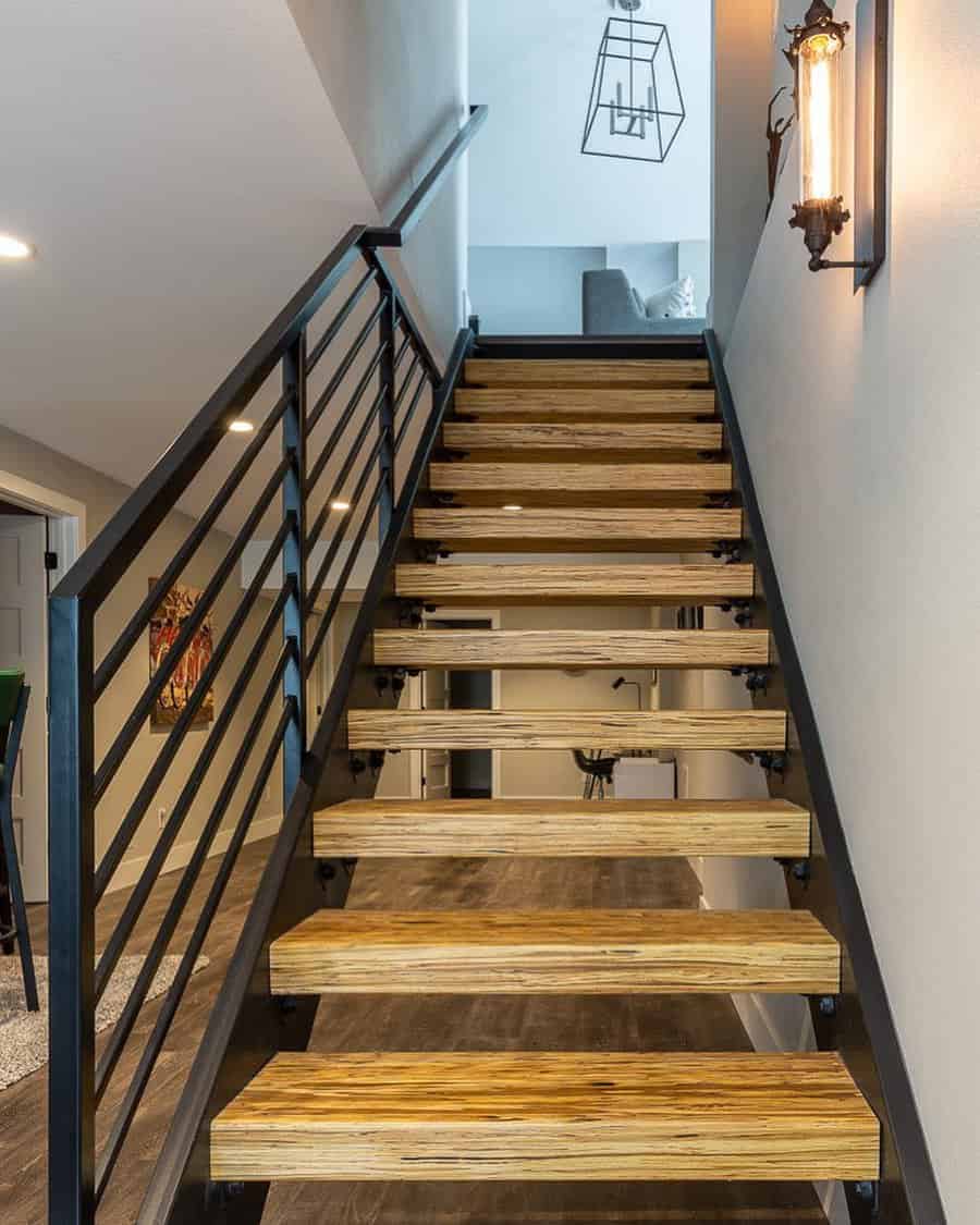 Staircase with sleek black railings and wooden steps