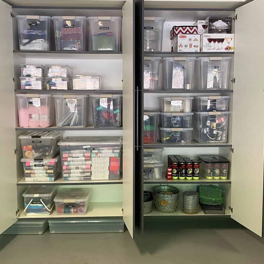 Transparent storage containers on shelves inside a cabinet