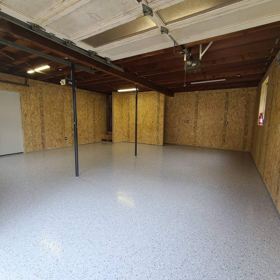 Garage with white floor and wooden walls