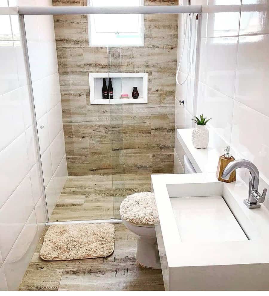small bathroom with off-white walls and wood tile flooring