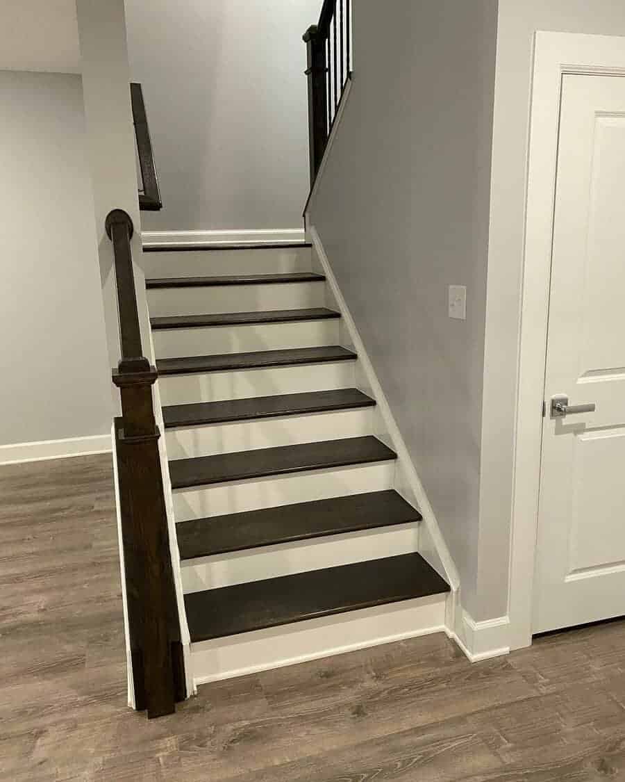 Wooden stairway against a white wall