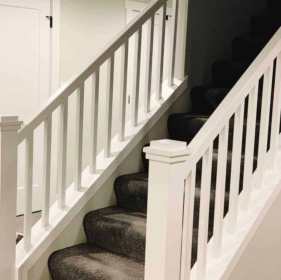 Staircase with white railings and carpeted stairs