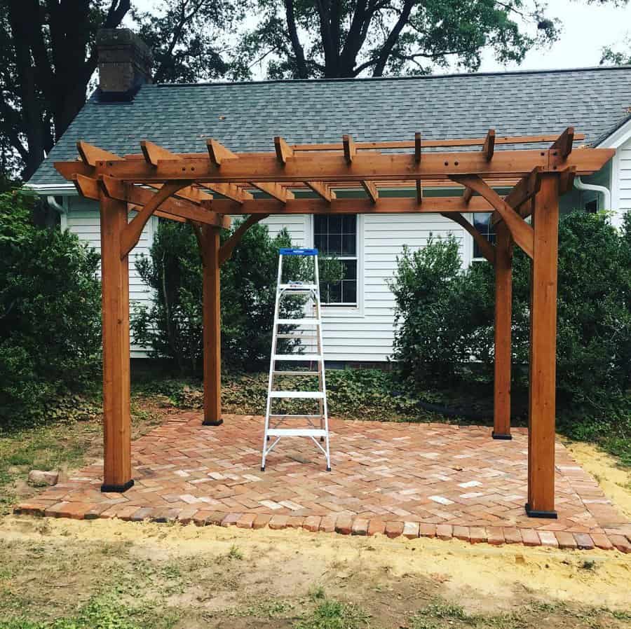 Backyard pergola with red bricks floor