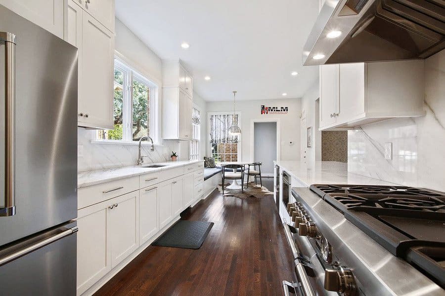 Bright galley kitchen with marble counters