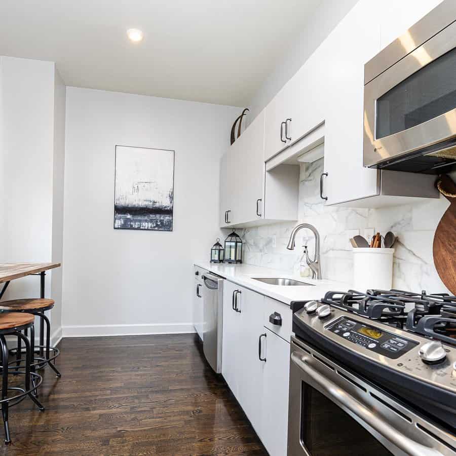 Chic kitchen with marble backsplash and art