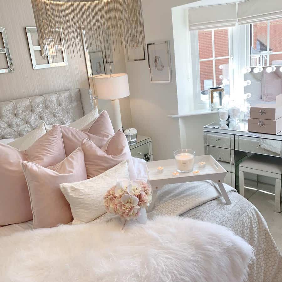 Chic bedroom with pink pillows and a luxurious chandelier