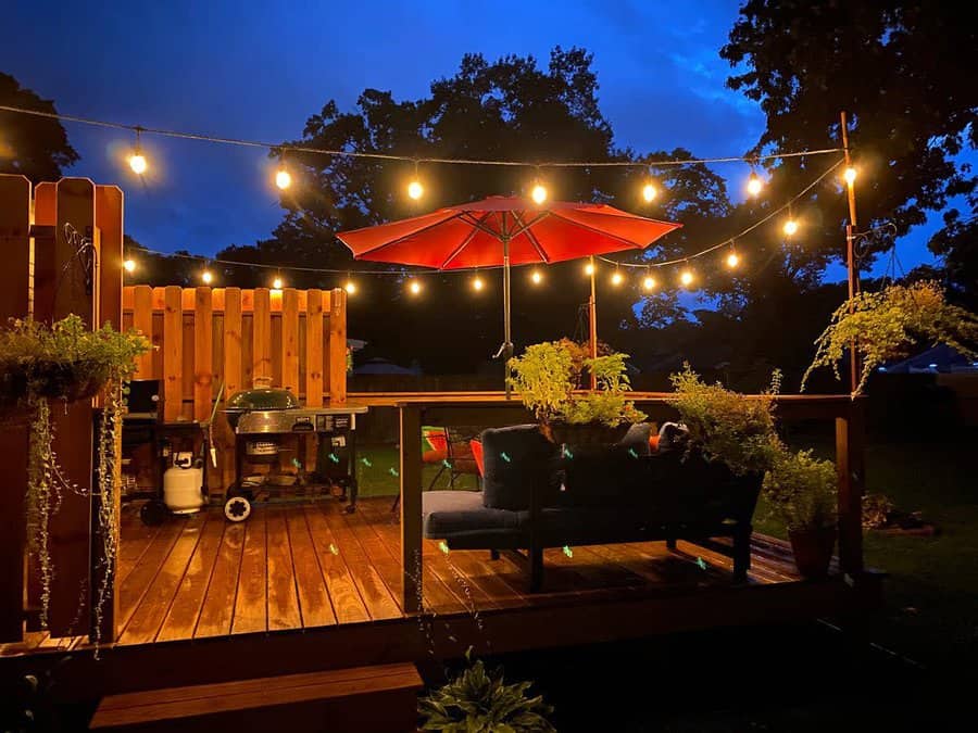 Backyard bar with hanging string lights and hung plants