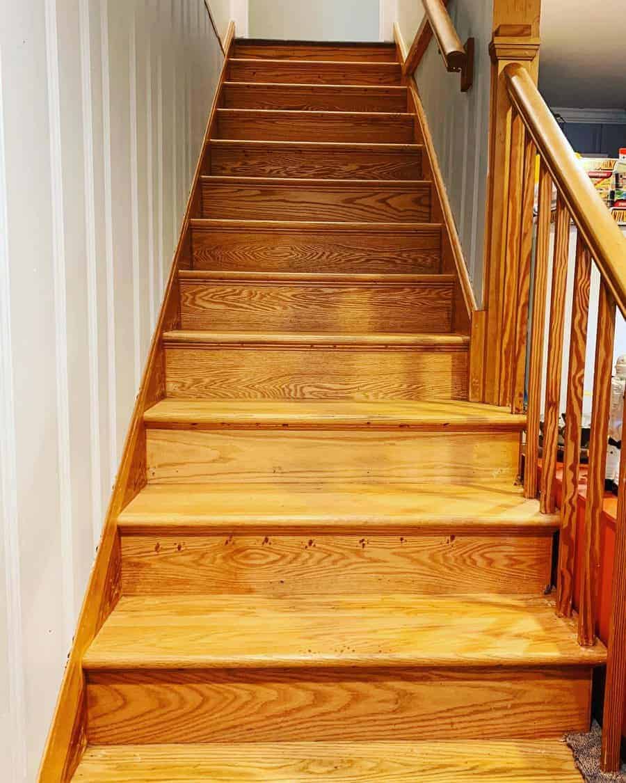 Wooden staircase with white wall