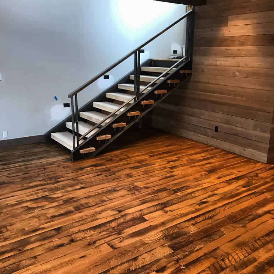 Modern staircase with wooden steps and a metal railing