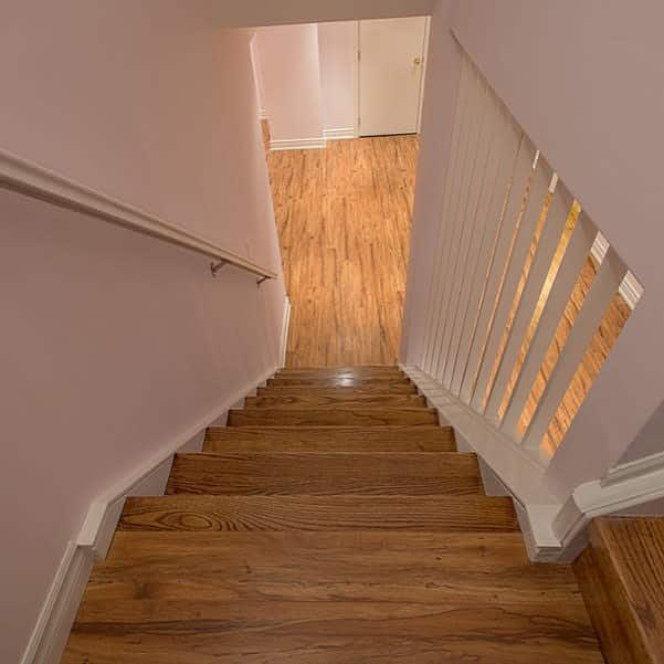 Wooden stairway with white railing