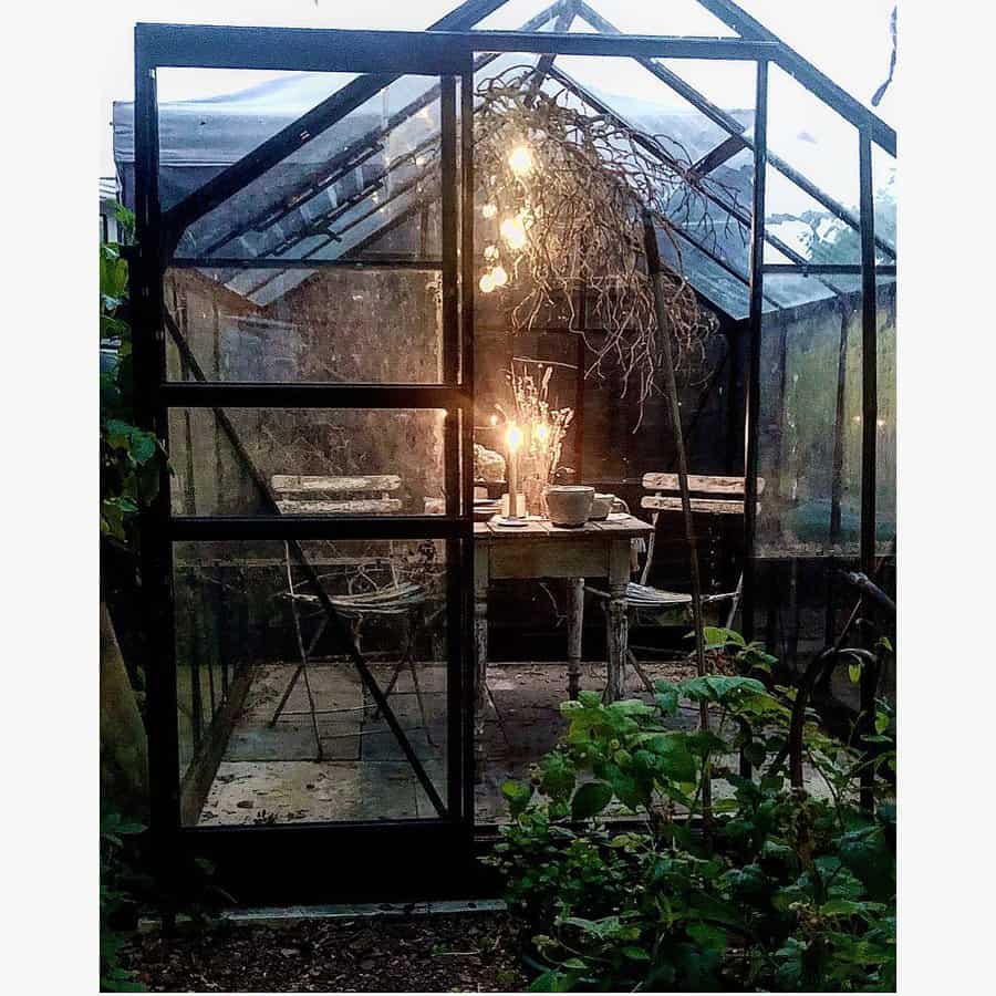 Glass greenhouse with table and chairs