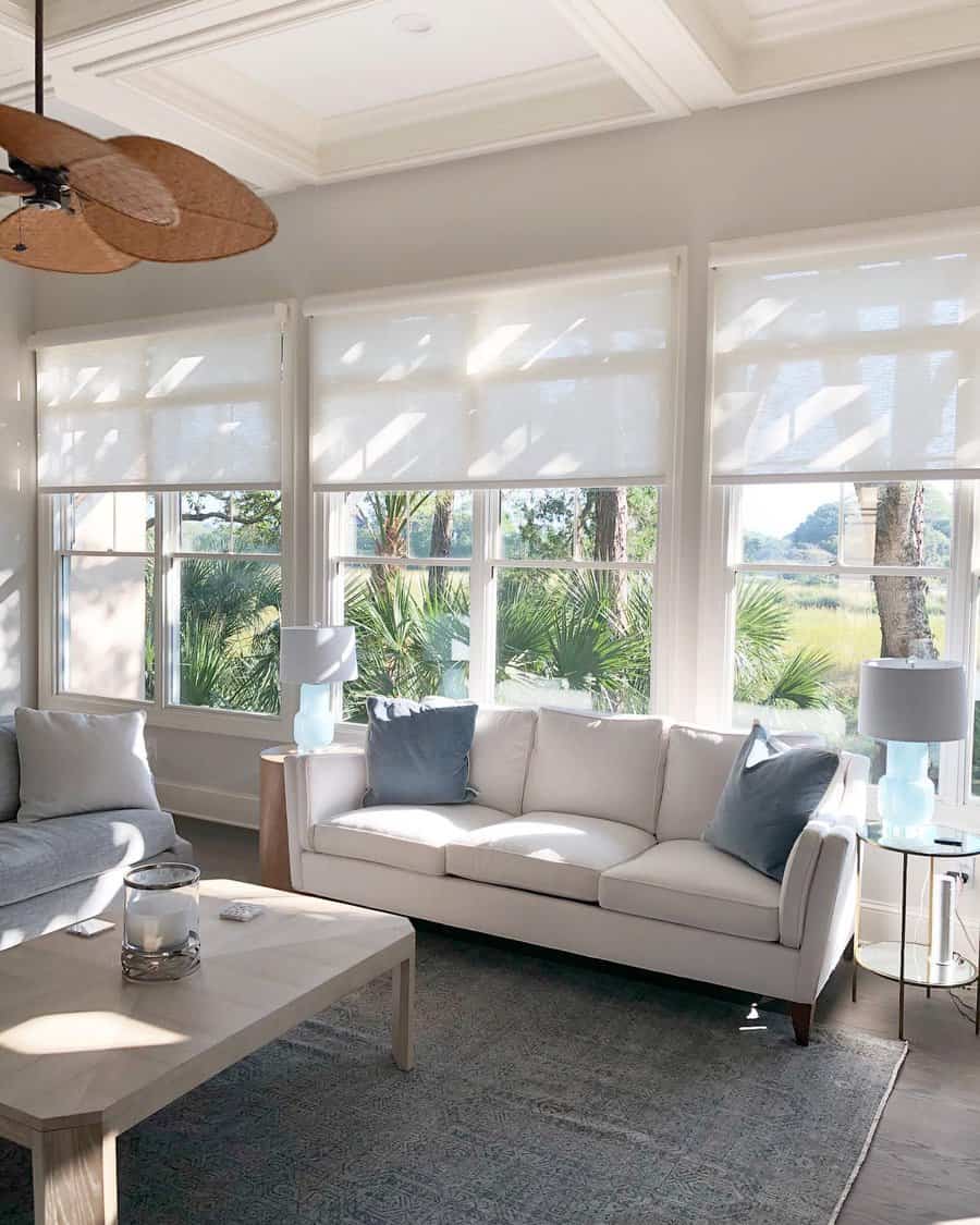 Airy living room with sheer roller shades and ocean view