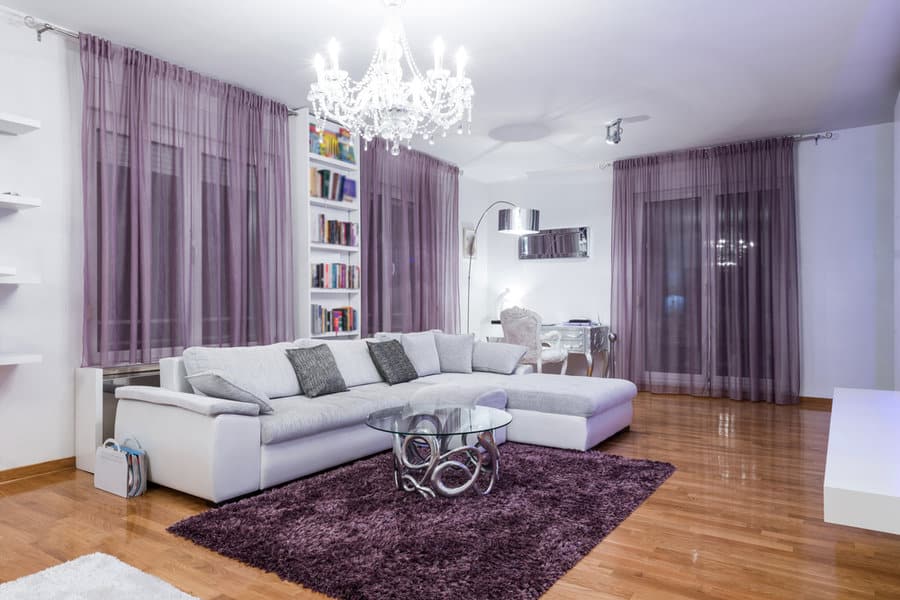 Modern living room with plush sofa and lilac curtains