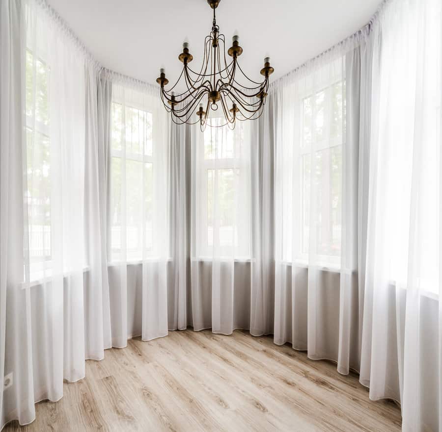 Bright room with sheer curtains and elegant chandelier