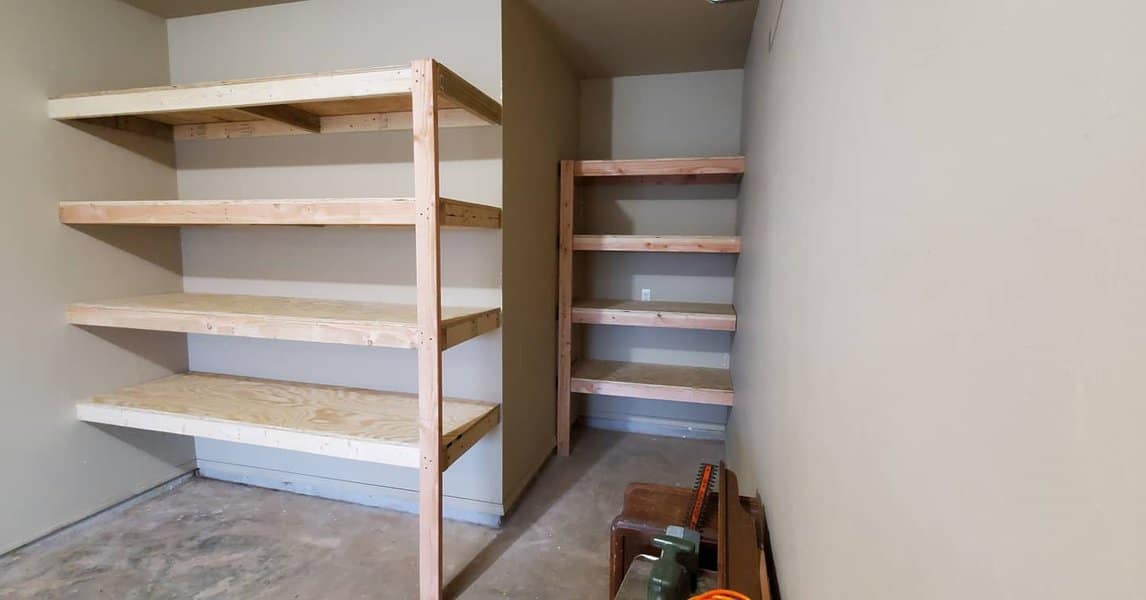 A compact garage featuring wooden shelves for storage