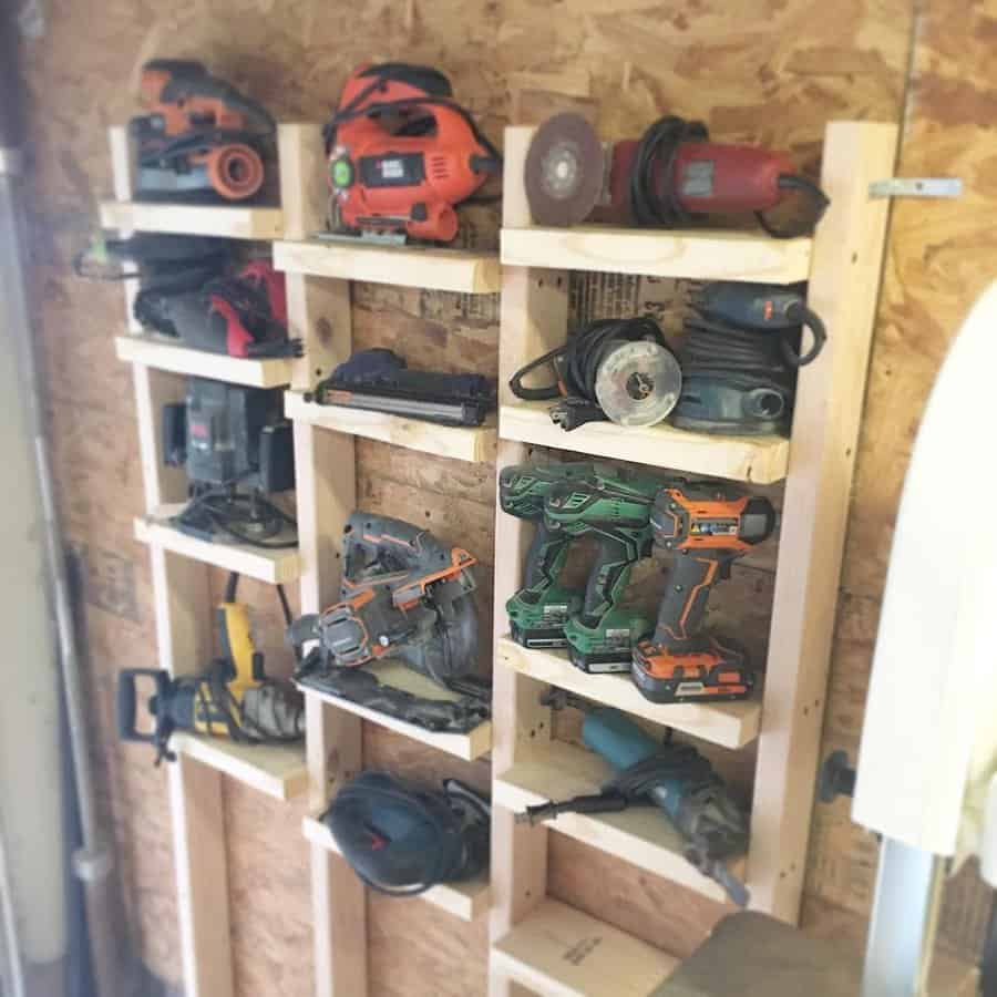 A compact garage featuring wooden shelves for storage