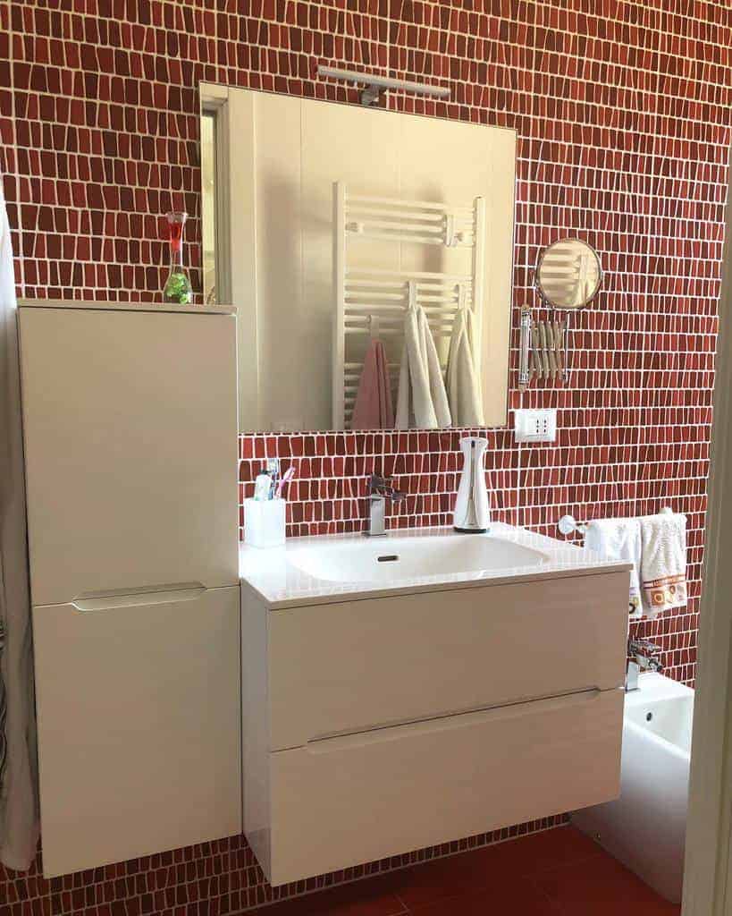 small bathroom with terracotta mosaic wall 