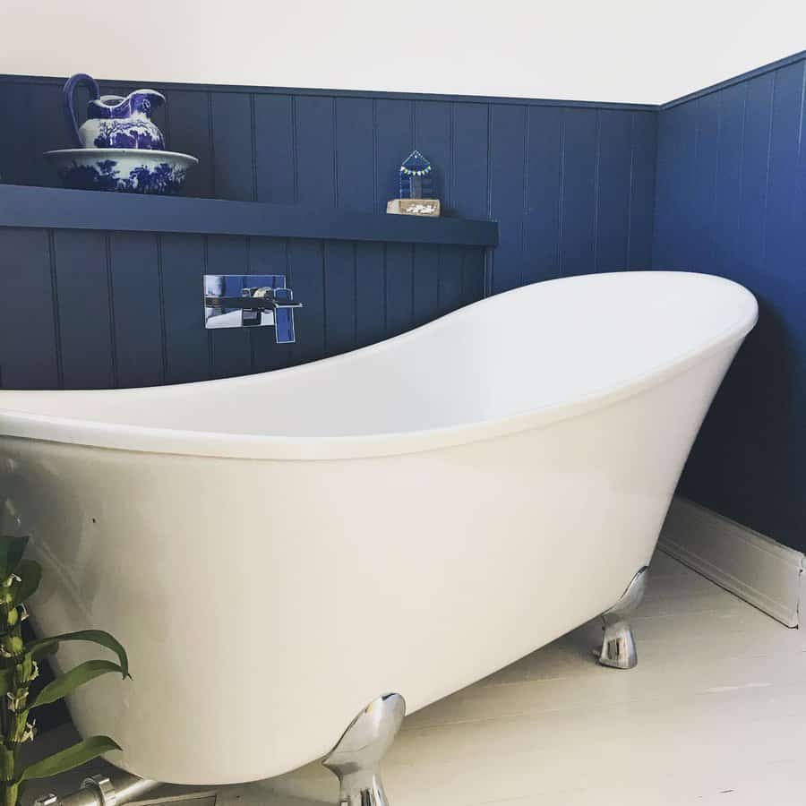 blue bathroom with vintage standalone bathtub