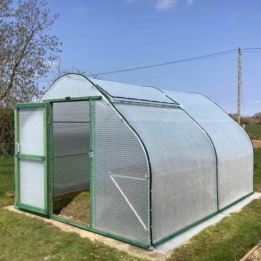 Open side door reveals the greenhouse interior