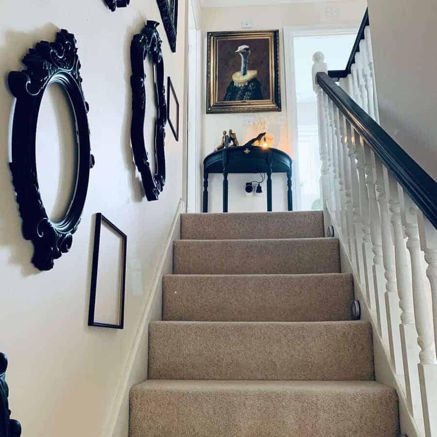 Monochrome staircase adorned with framed pictures