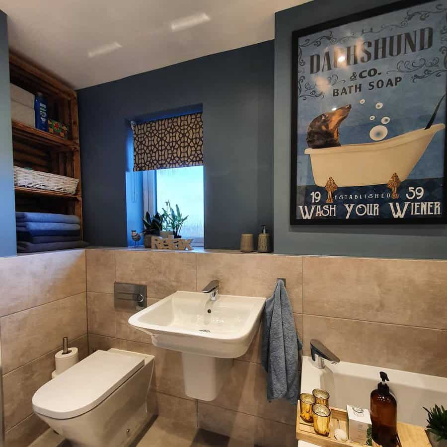 blue bathroom with framed wall art 