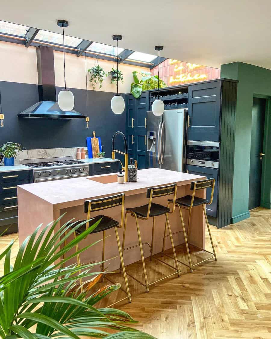 Trendy kitchen with skylights and a pink island