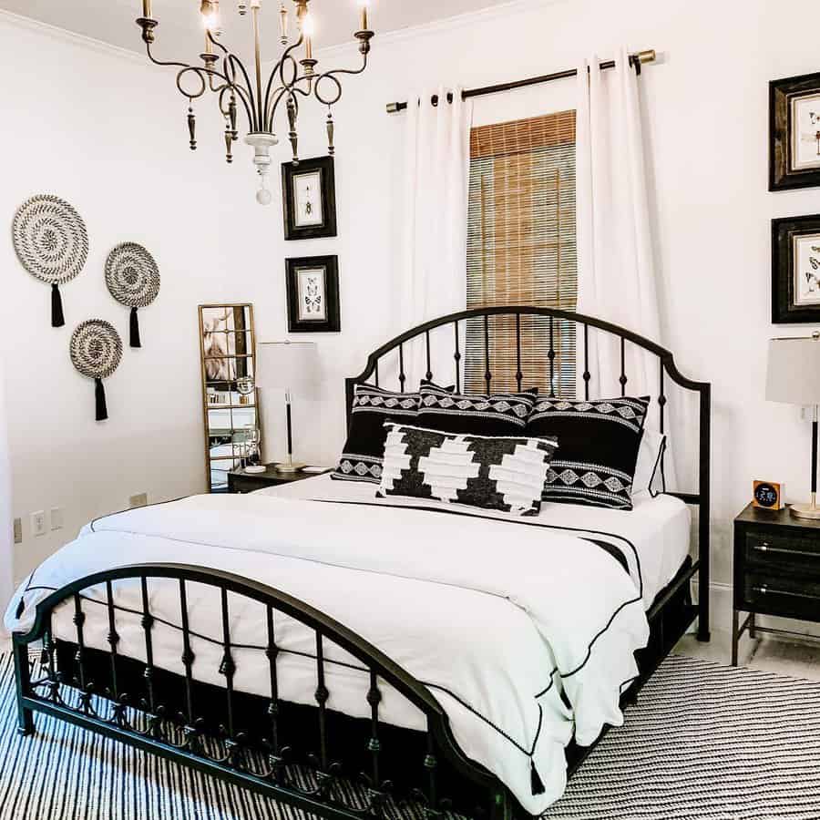 Stylish bedroom with iron bed frame and tribal-patterned pillows