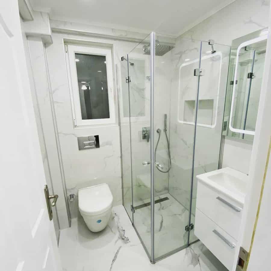 Small bathroom with white marble walls and flooring