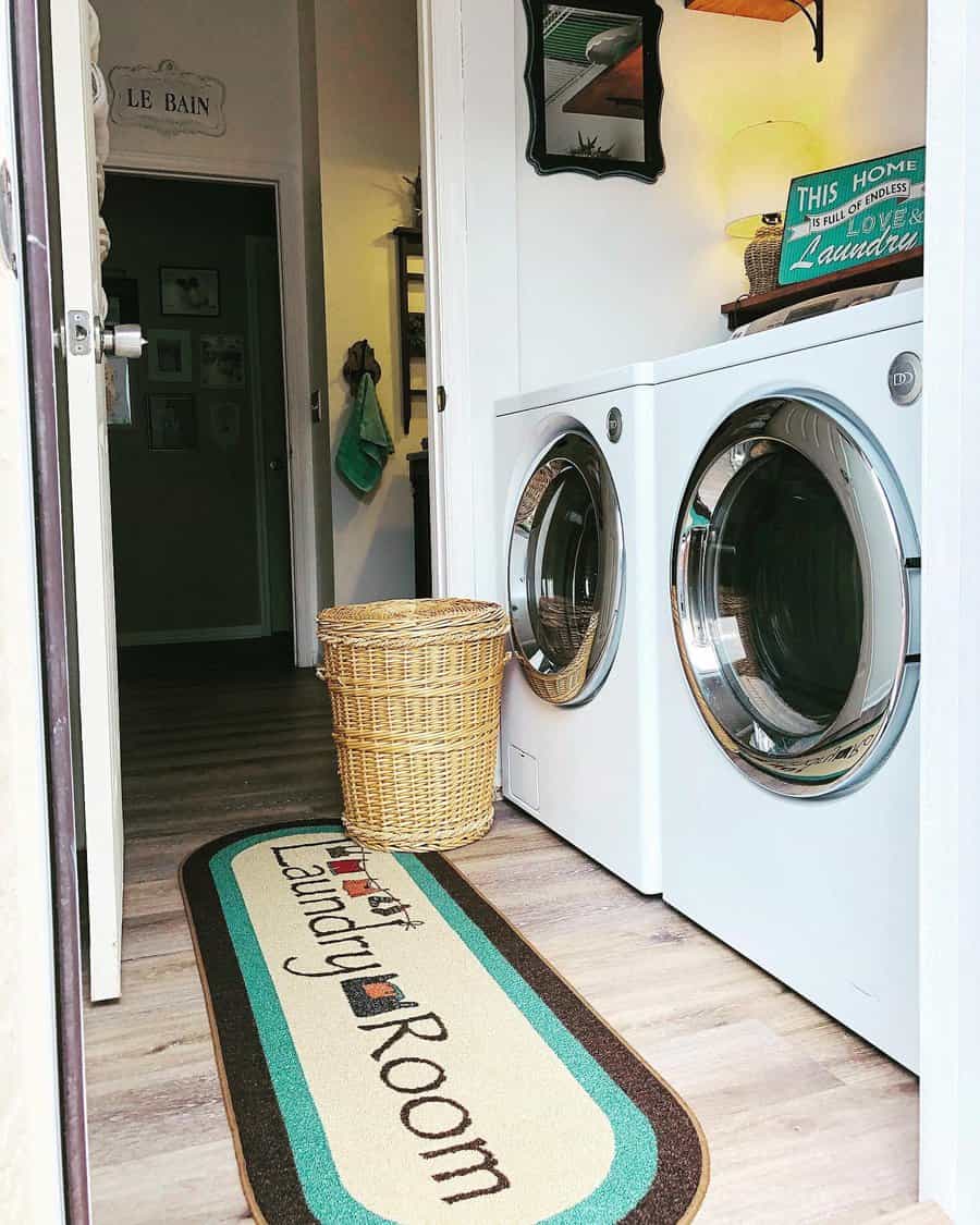 Laundry room with a rug that reads "Laundry Room," a wicker basket, and a washer and dryer set against the wall