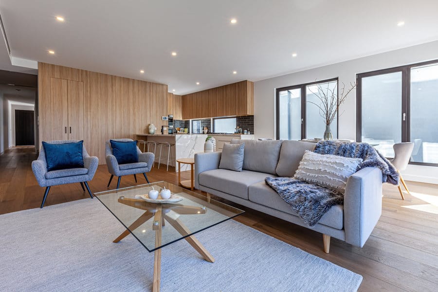 Modern living room with glass coffee table with wooden legs