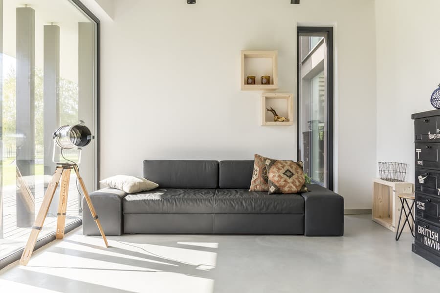 Minimalist living room with black sofa and cube wall shelves