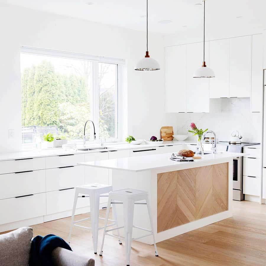 white cabinets with wood kitchen island and flooring