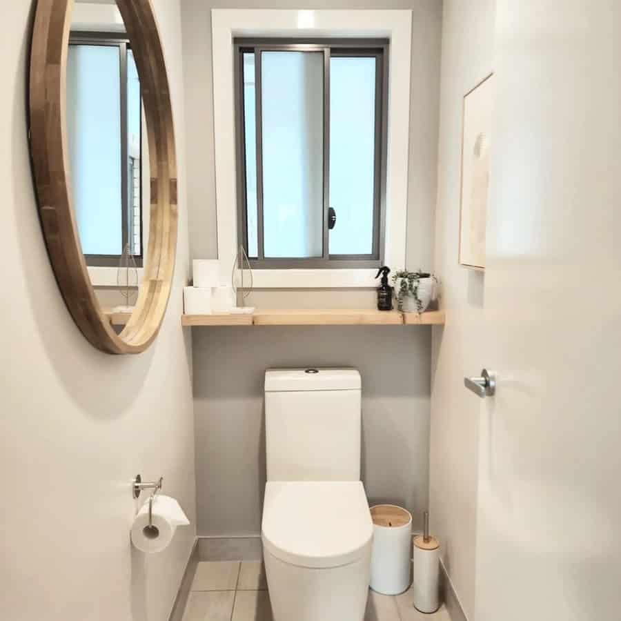 Powder room with round accent mirror