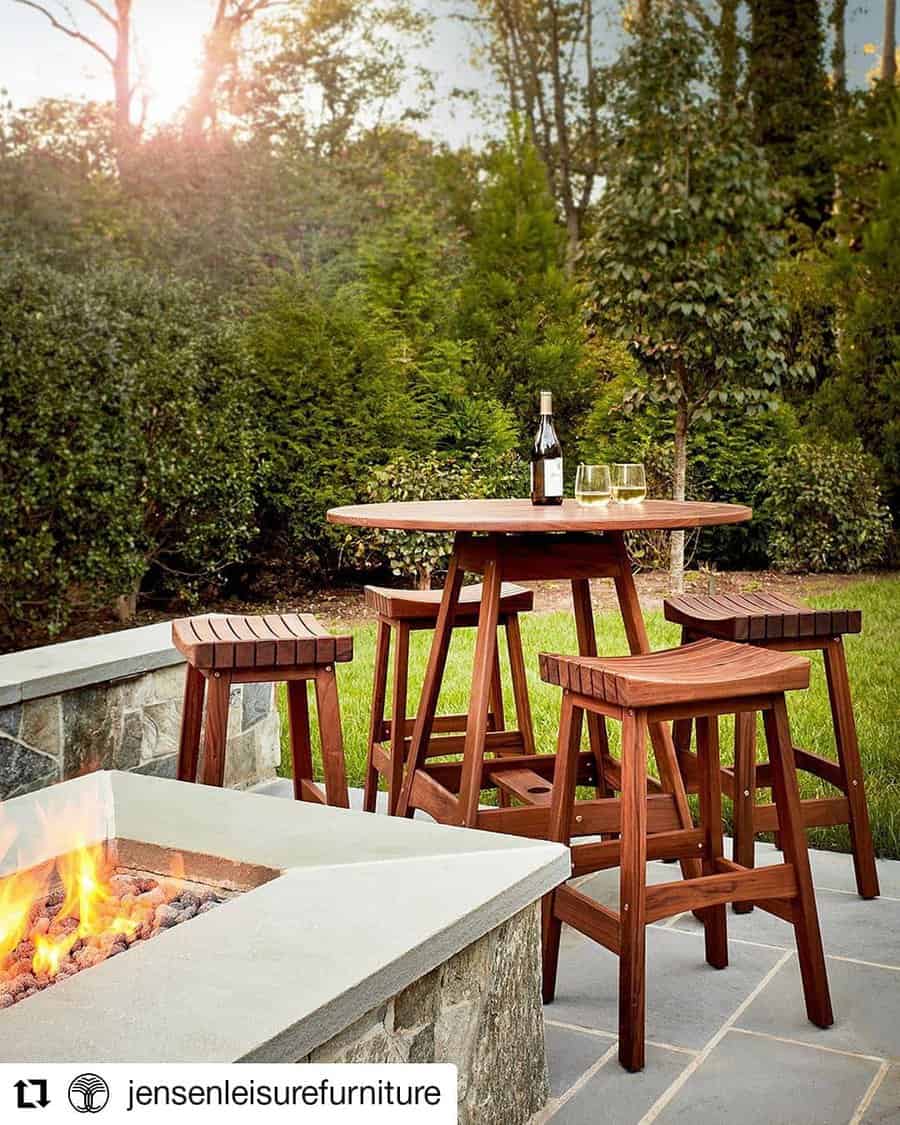 round wooden table accompanied by wooden bar stools