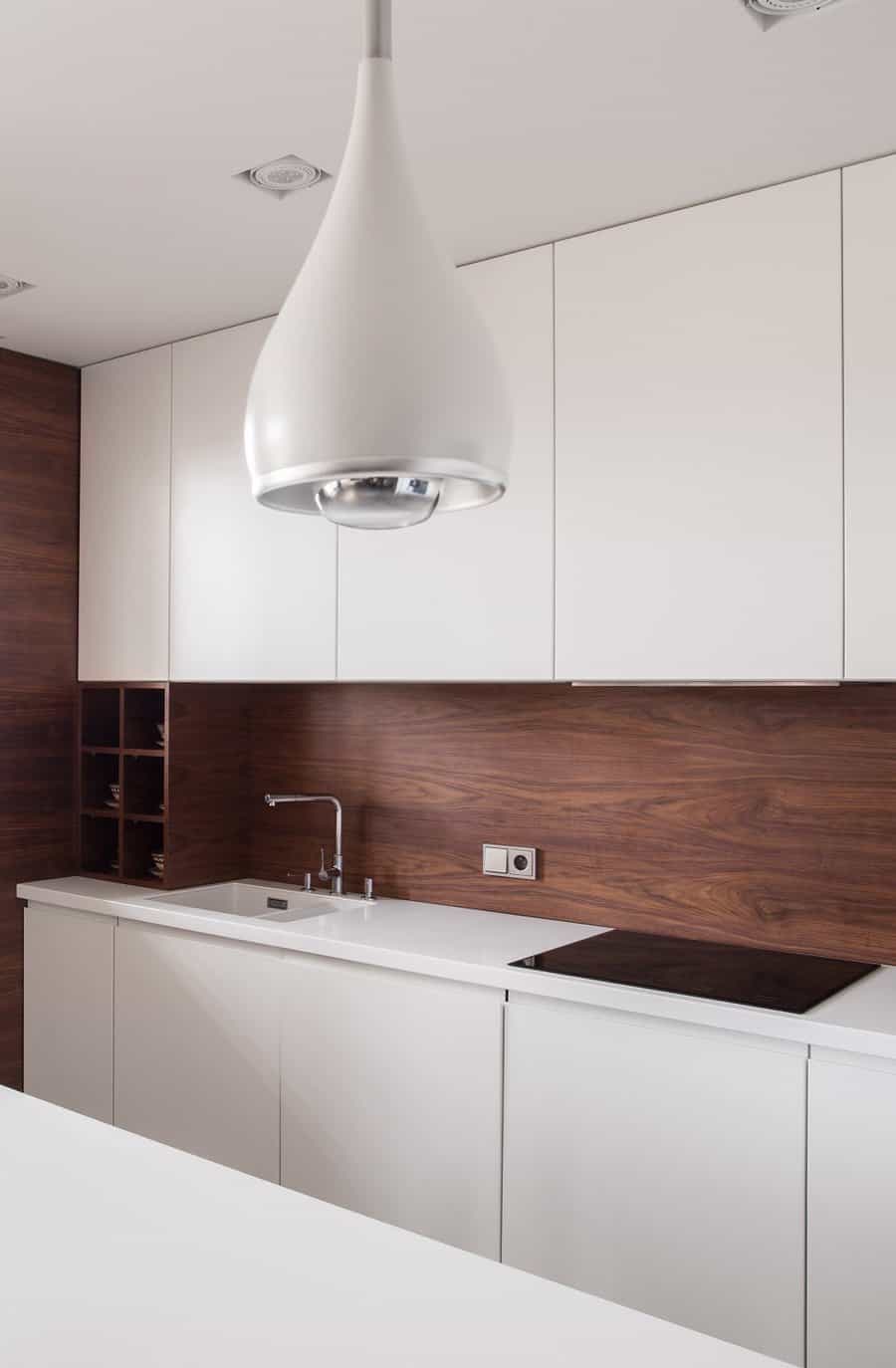 white cabinets with wood backsplash