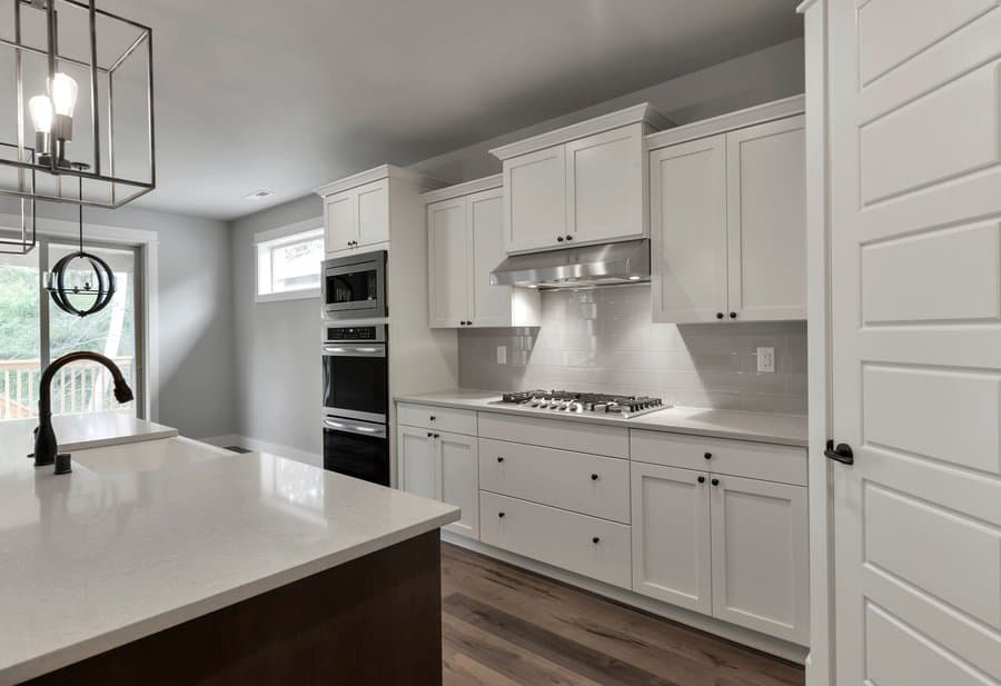 white kitchen cabinets with subway tile backsplash