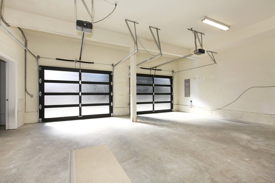 Empty garage interior with open glass door