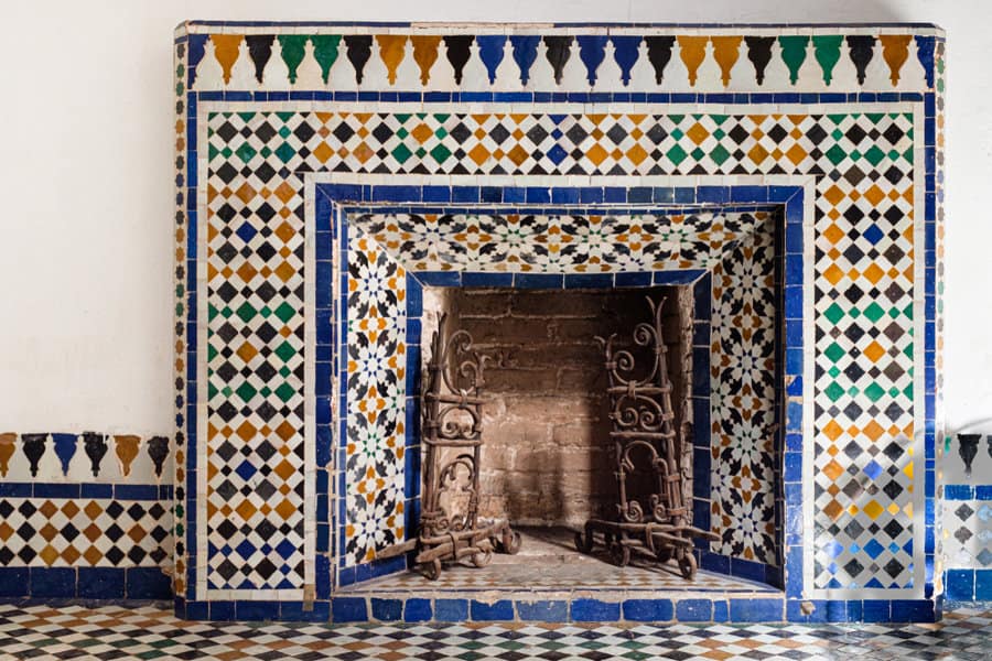 Moroccan tiled fireplace against white wall