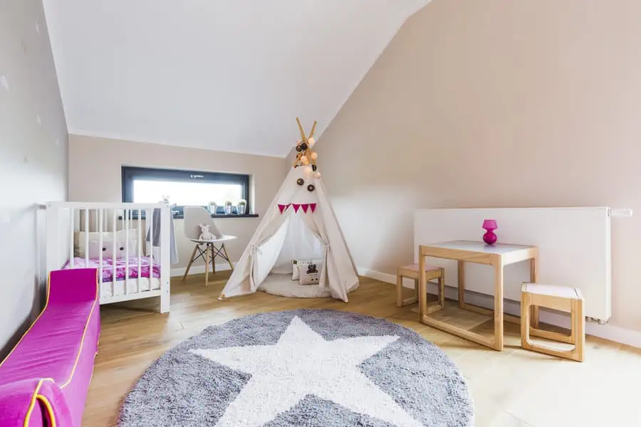 Spacious child's room with teepee and star patterned rug