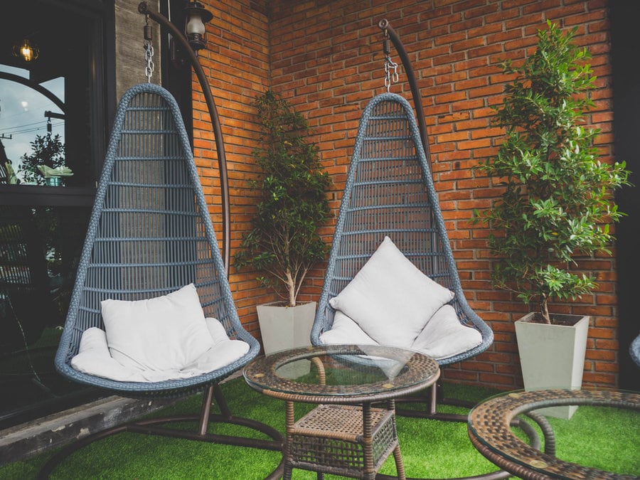 Hanging wicker chairs with a stand