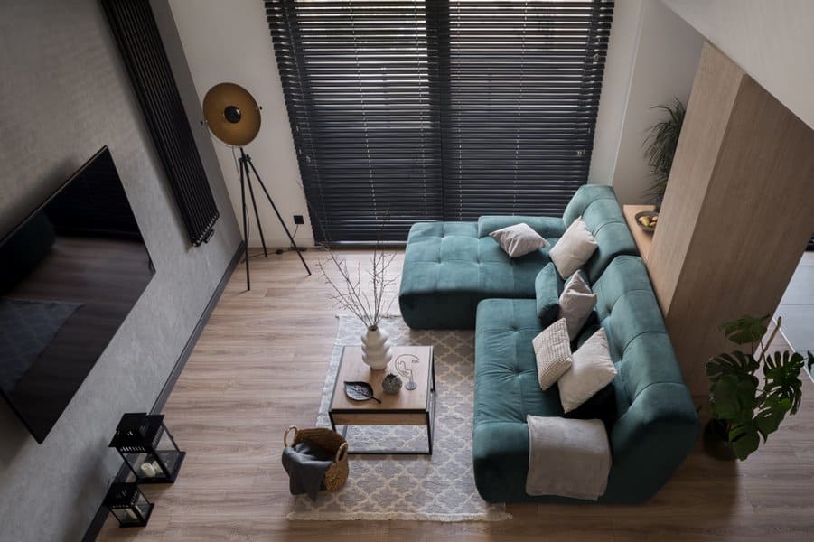 Modern living room with teal sofa and stylish decor
